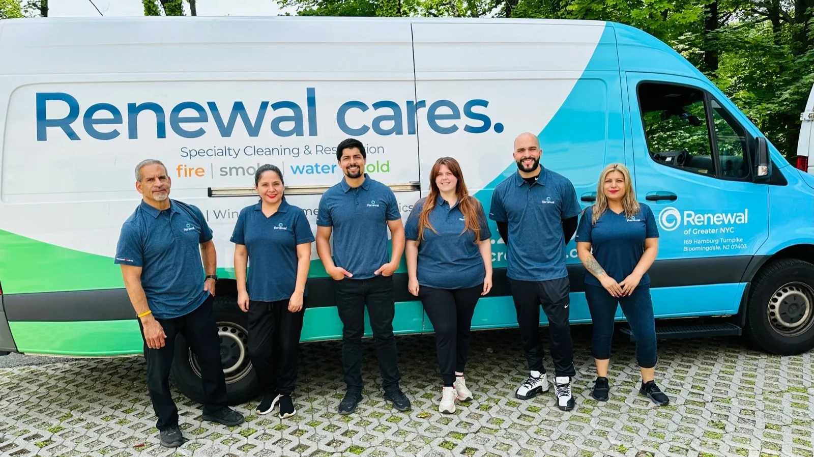 Six employees stand in front of a Renewal Claim Solutions van ready to provide home water damage repair services.